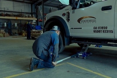 Service Technician Under Jacked Truck