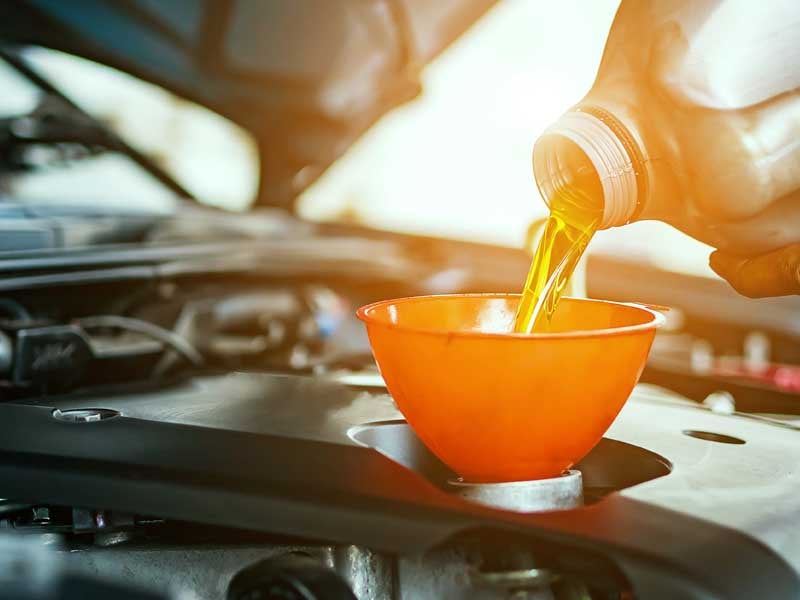 Technician performing oil change at Salinas Valley Ford